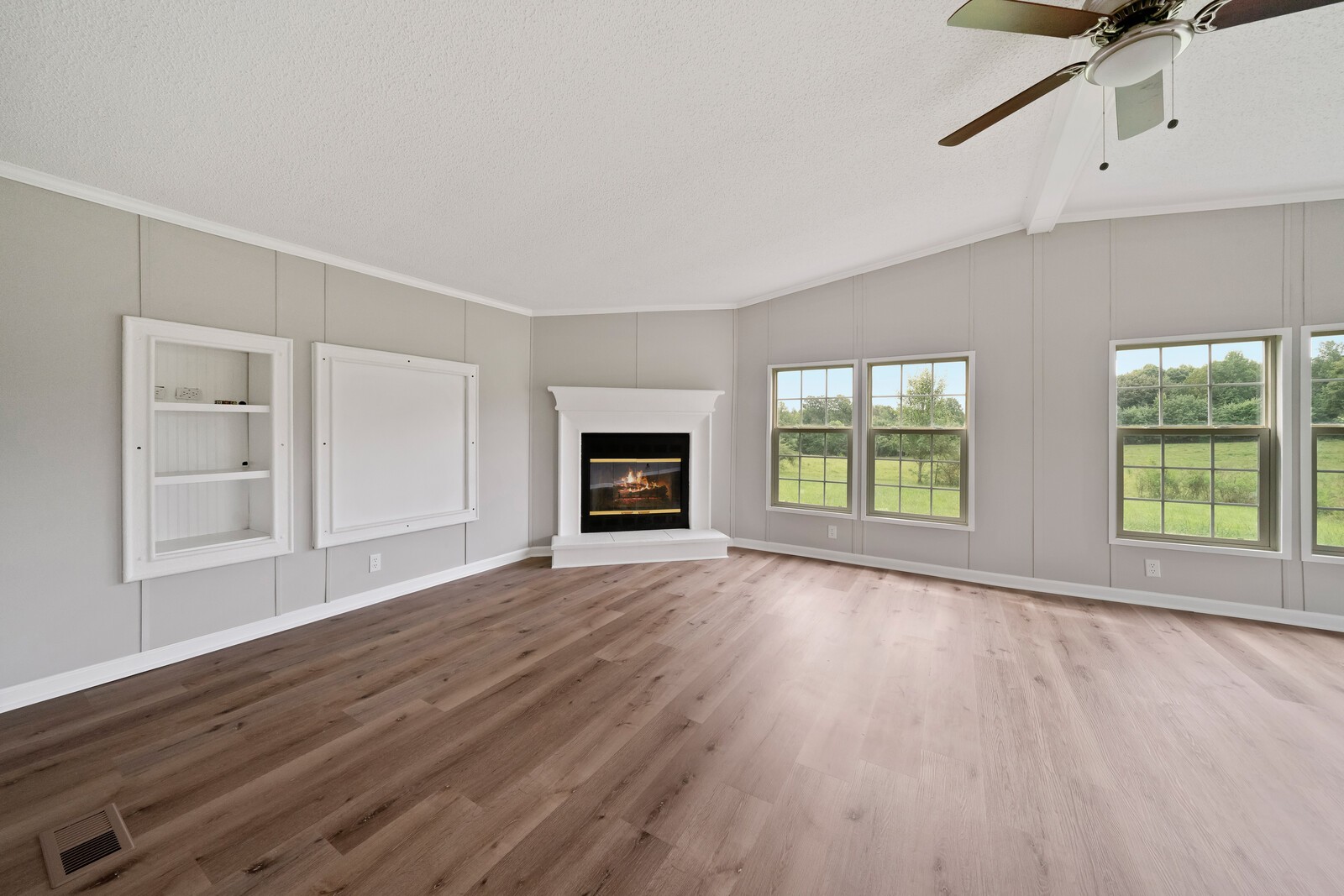 450 Obie Adcock Road Smithville, TN 37166 - Photo 13 of 30 a view of an empty room with wooden floor and a window