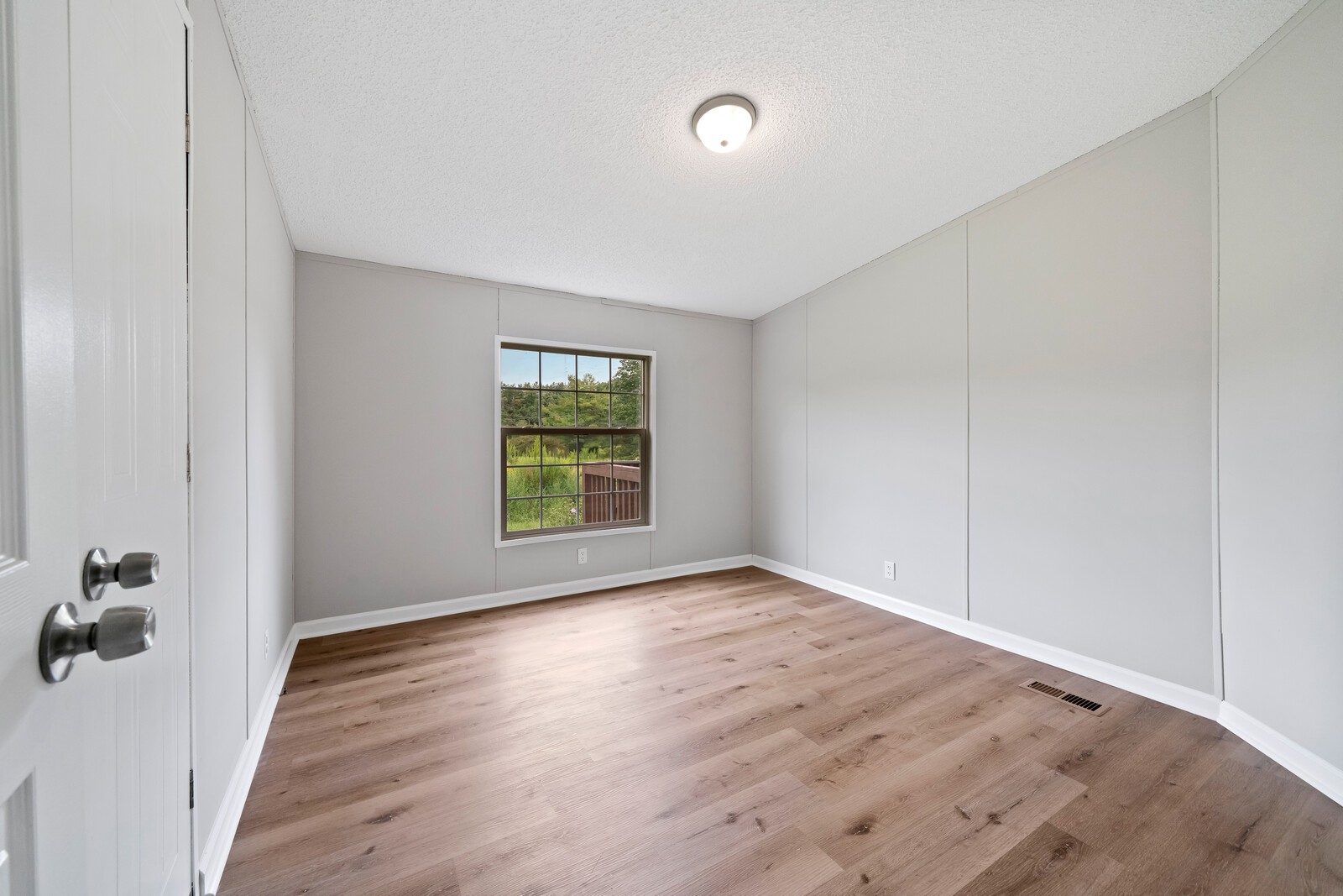 450 Obie Adcock Road Smithville, TN 37166 - Photo 20 of 30 an empty room with wooden floor and windows