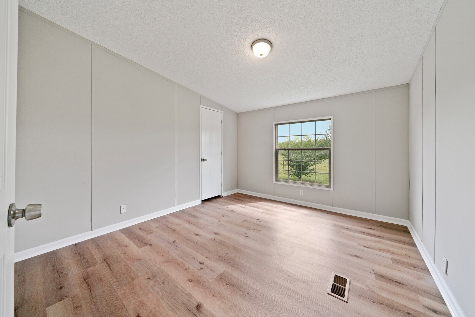 450 Obie Adcock Road Smithville, TN 37166 - Photo 22 of 30 a view of an empty room with a window and wooden floor