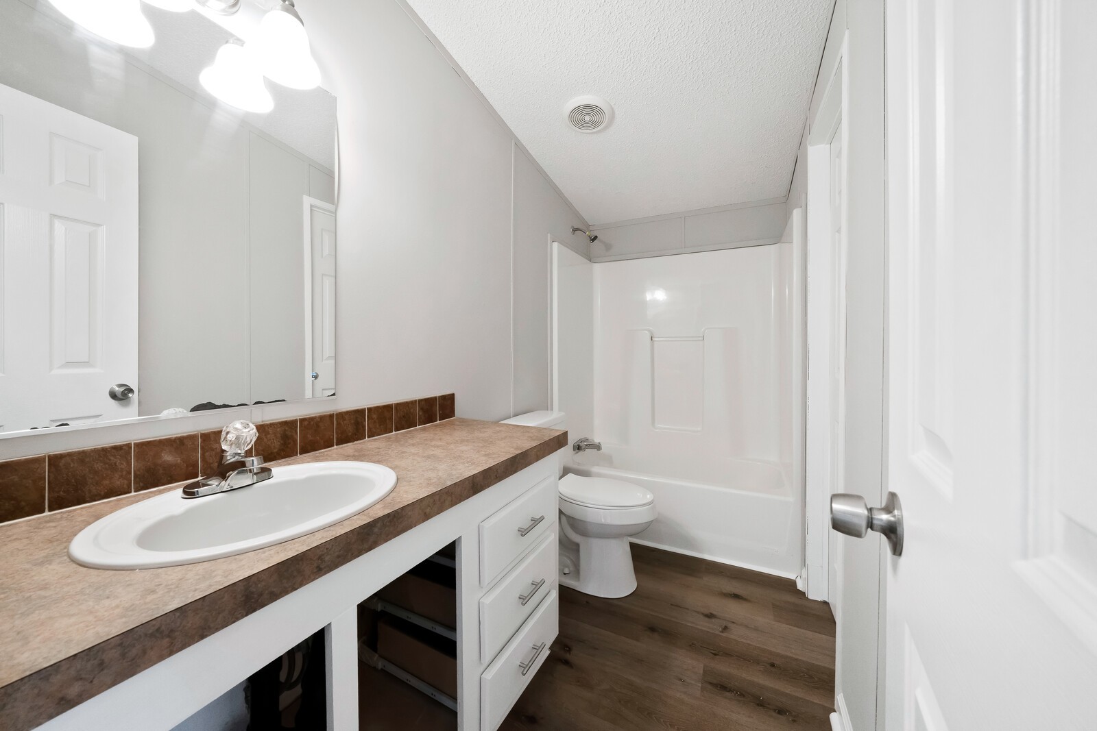 450 Obie Adcock Road Smithville, TN 37166 - Photo 23 of 30 a bathroom with a granite countertop sink and a mirror