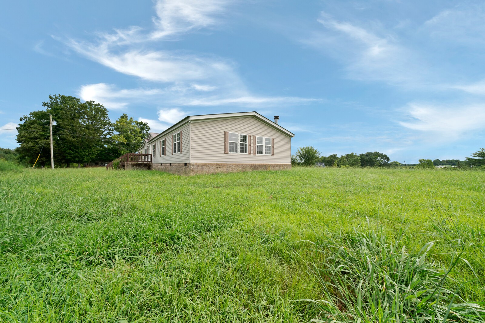 450 Obie Adcock Road Smithville, TN 37166 - Photo 26 of 30 a view of a house with a yard and garage