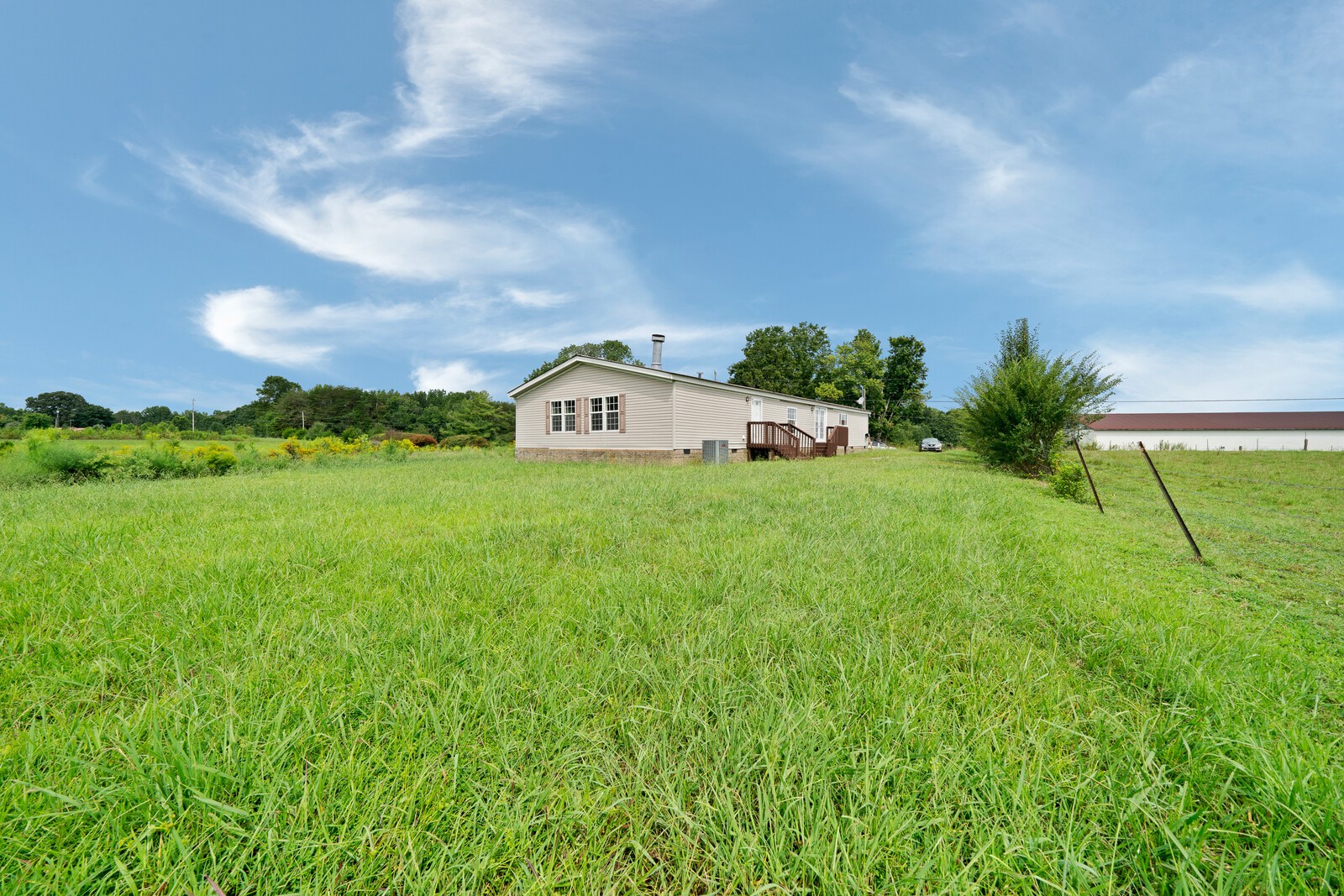 450 Obie Adcock Road Smithville, TN 37166 - Photo 27 of 30 a view of a garden with a building in the background