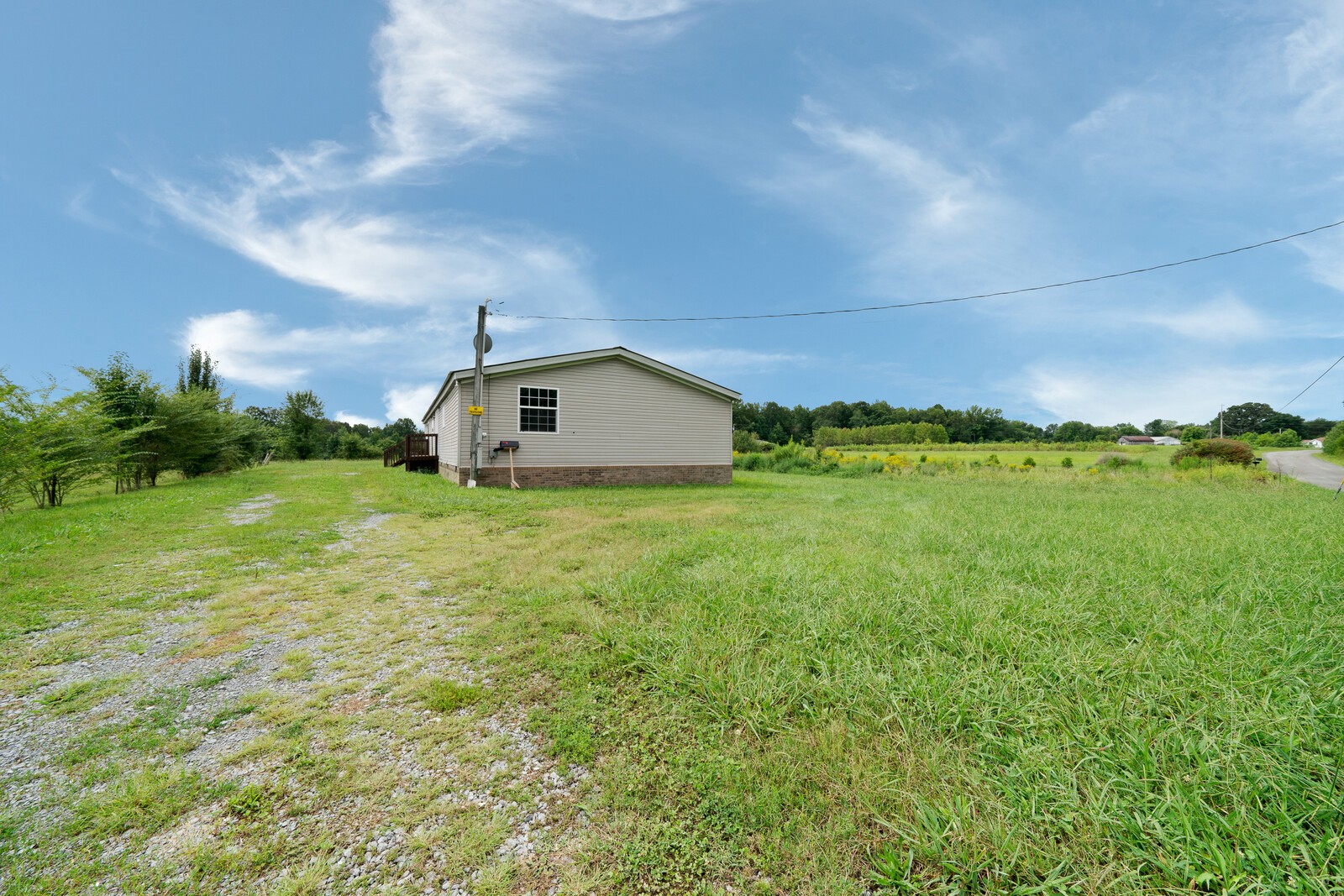 450 Obie Adcock Road Smithville, TN 37166 - Photo 29 of 30 a view of a big house with a big yard and large trees
