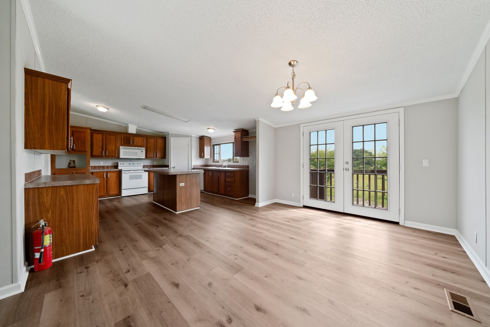 450 Obie Adcock Road Smithville, TN 37166 - Photo 7 of 30 a view of a kitchen with wooden floor and a kitchen