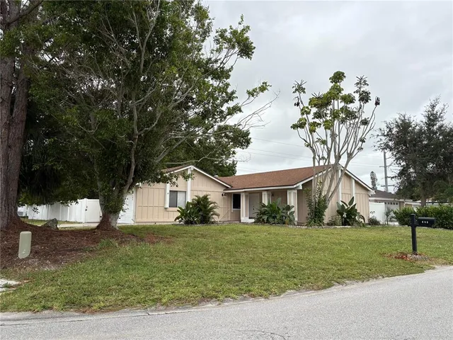 a front view of house with yard and green space