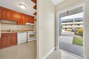 a kitchen with granite countertop a refrigerator and a stove