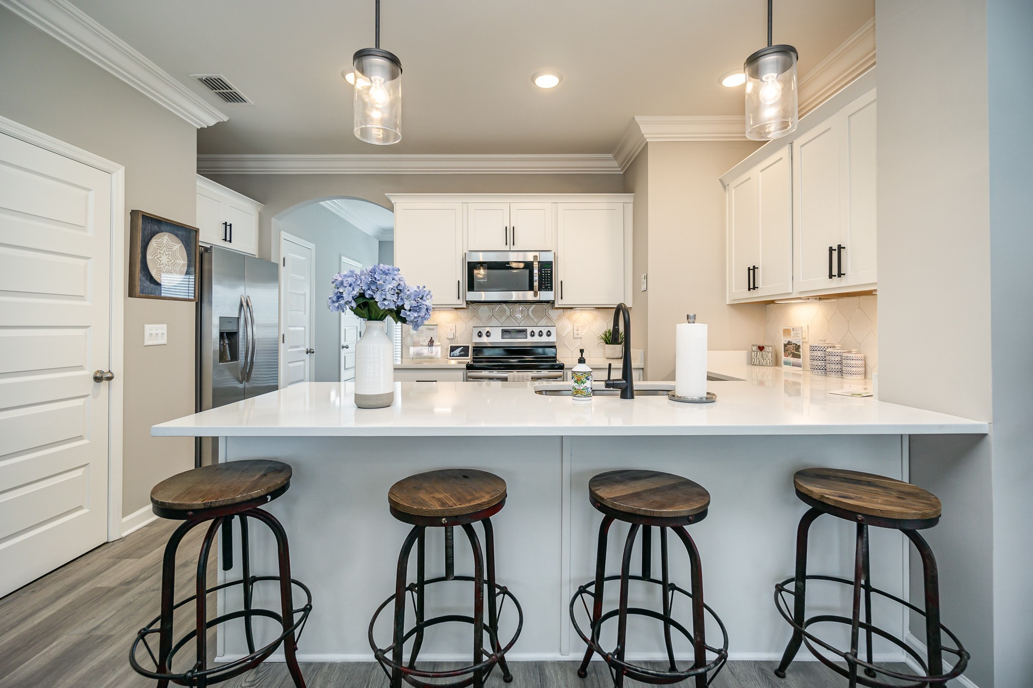 1748 Fenway Loop Antioch, TN 37013 - Photo 11 of 38 a kitchen with stainless steel appliances a table and chairs in it