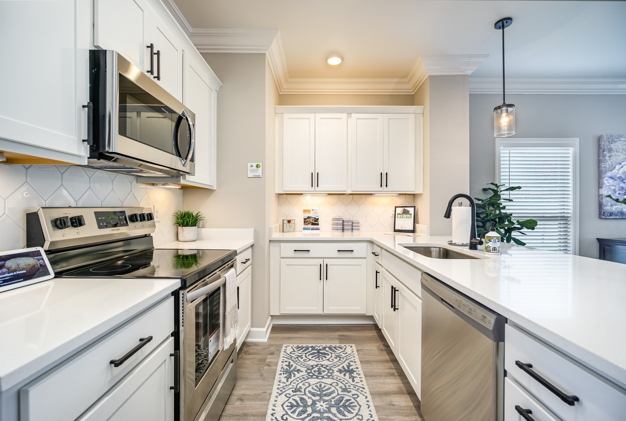 1748 Fenway Loop Antioch, TN 37013 - Photo 12 of 38 a kitchen with stainless steel appliances granite countertop a sink and stove top oven