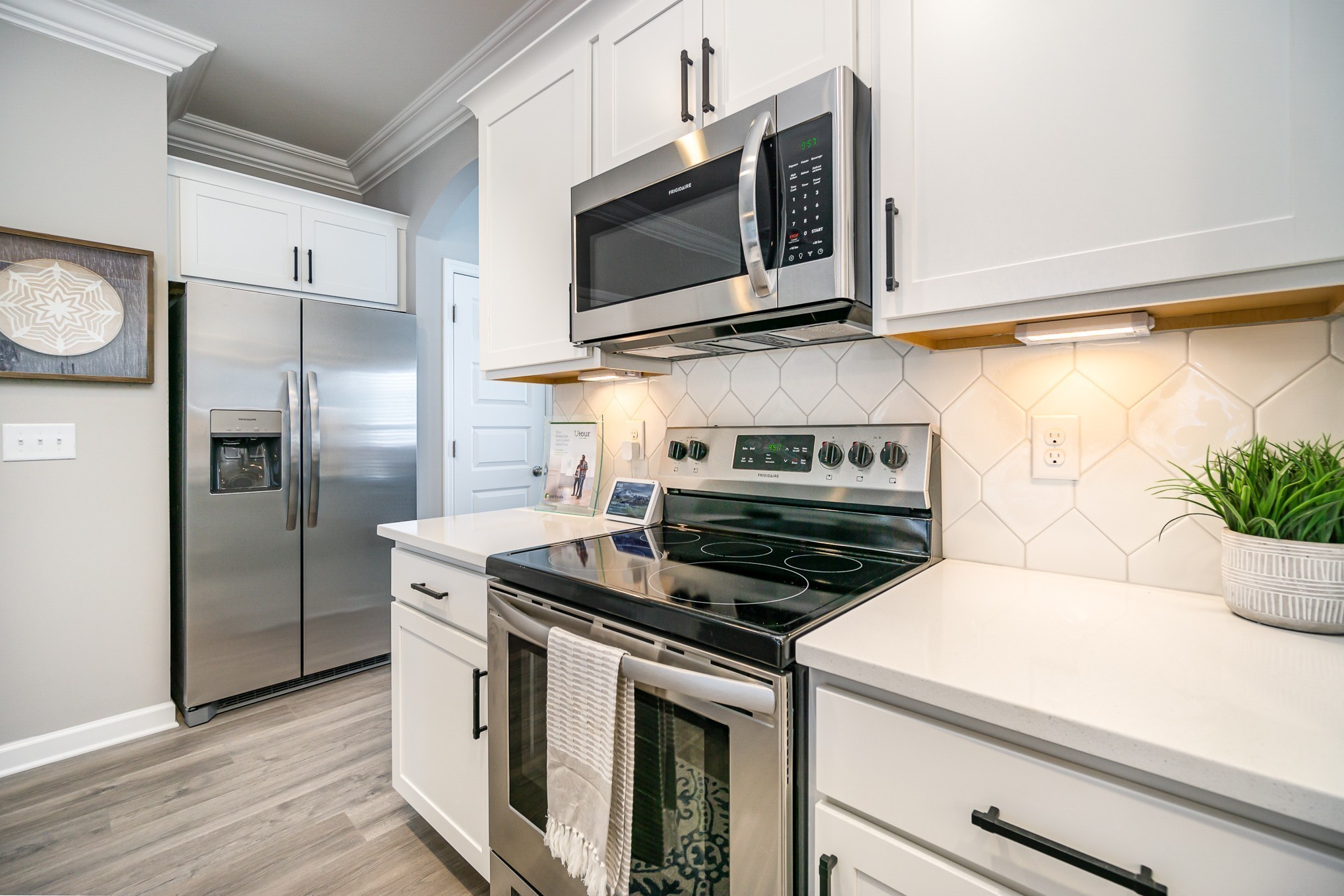 1748 Fenway Loop Antioch, TN 37013 - Photo 14 of 38 a kitchen with stainless steel appliances a stove a microwave and a hard wood floor