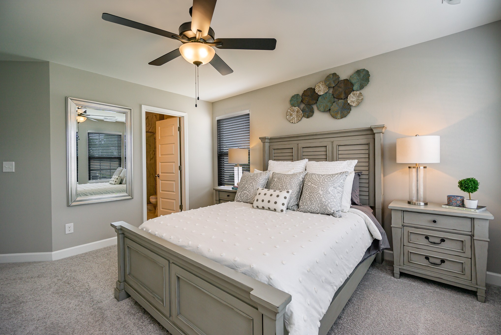 1748 Fenway Loop Antioch, TN 37013 - Photo 22 of 38 a bedroom with a bed a chandelier and a dresser