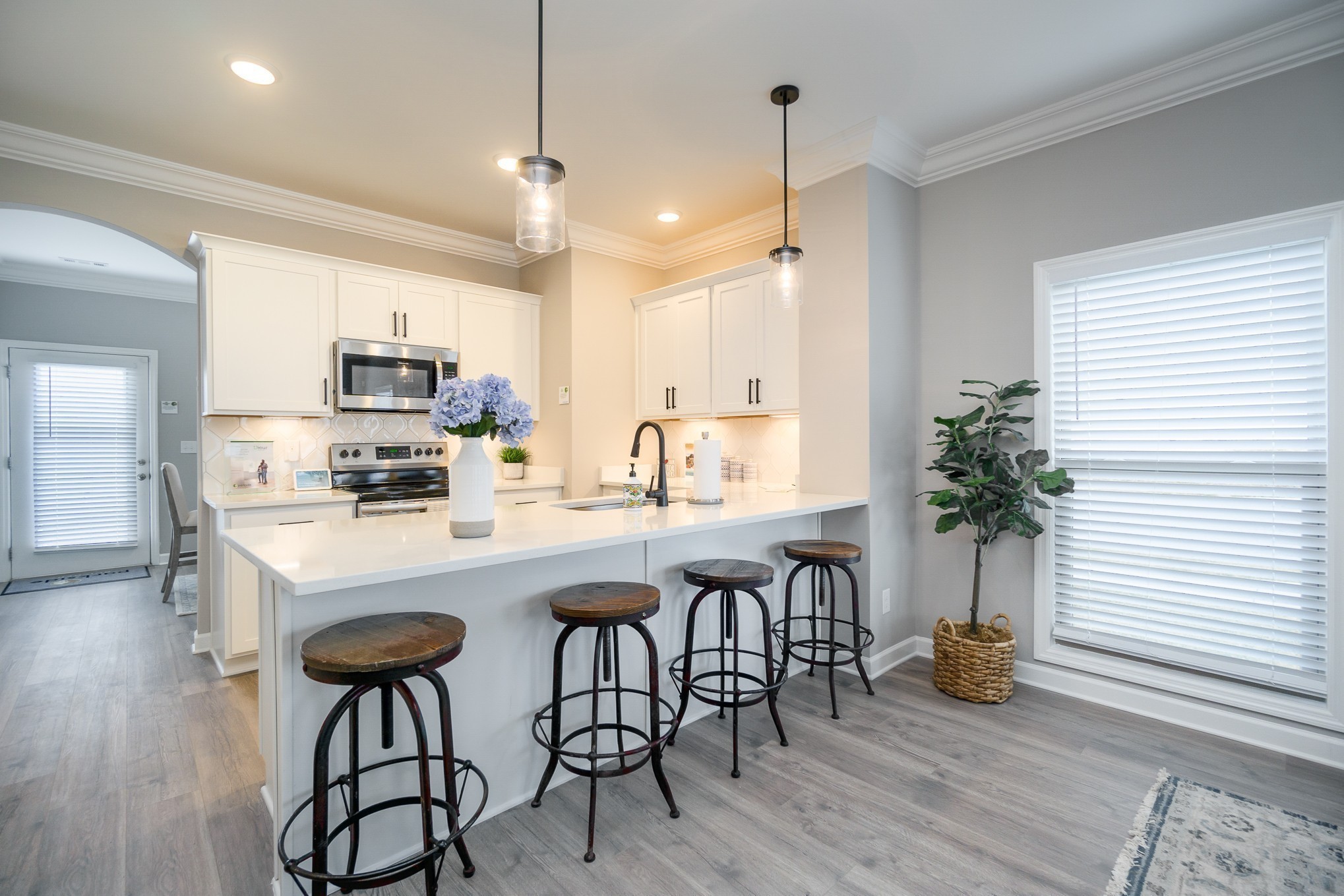 1748 Fenway Loop Antioch, TN 37013 - Photo 32 of 38 a kitchen with kitchen island a counter space a sink appliances and cabinets