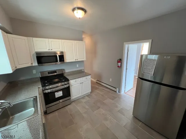 a kitchen with a refrigerator and a stove