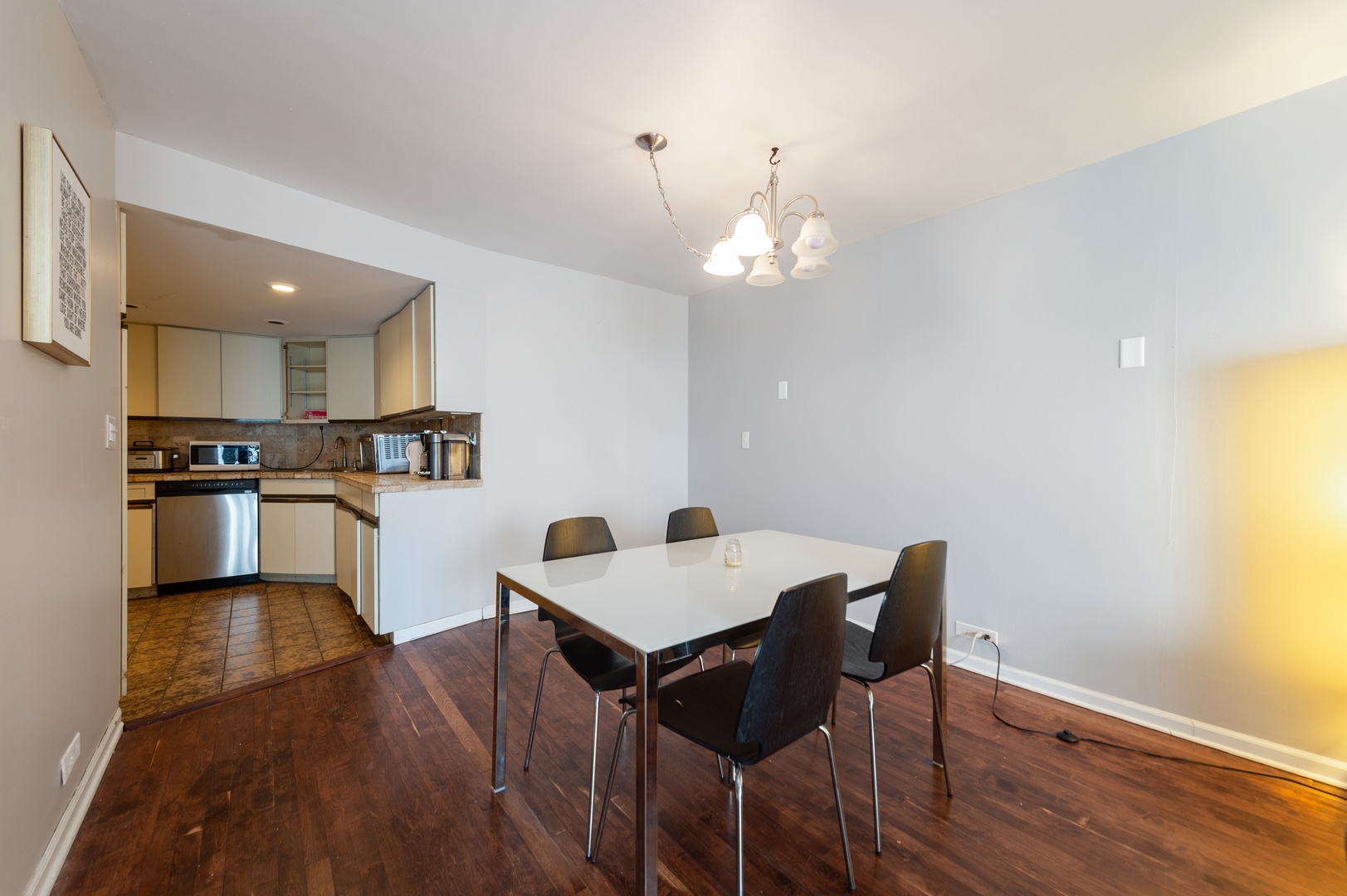 6033 North Sheridan Road, Unit 39G Chicago, IL 60660 - Photo 3 of 15 a view of a dining room with furniture and wooden floor