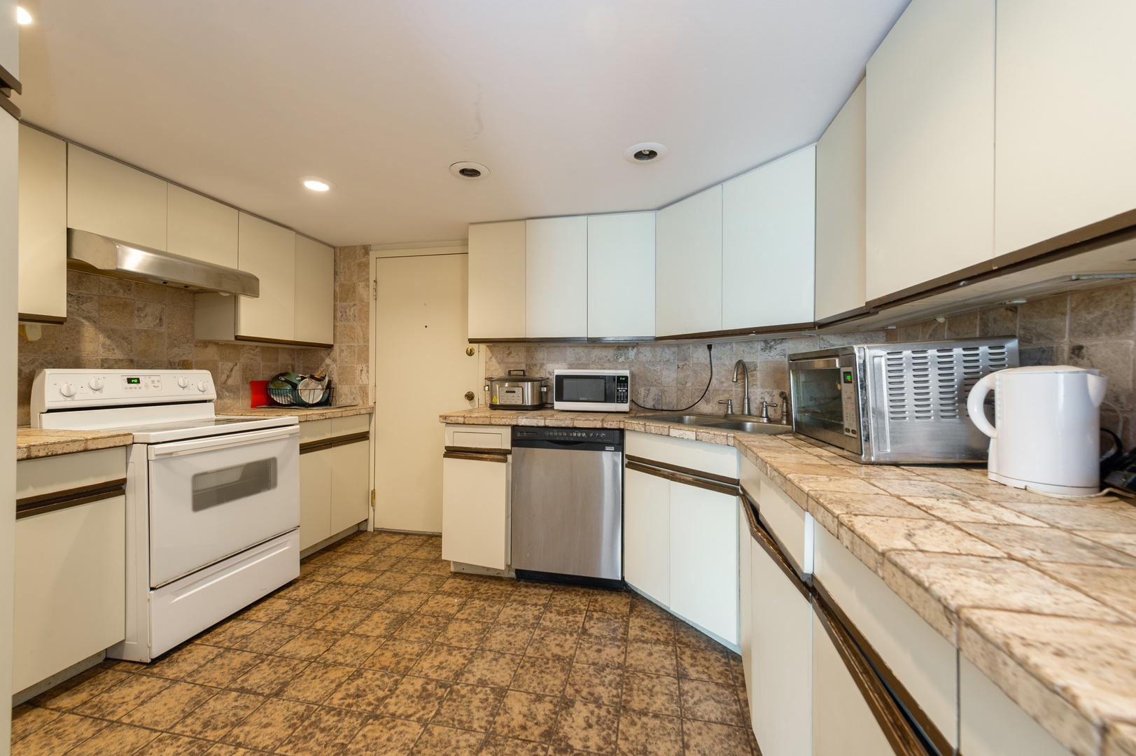 6033 North Sheridan Road, Unit 39G Chicago, IL 60660 - Photo 4 of 15 a kitchen that has a lot of white cabinets and stainless steel appliances