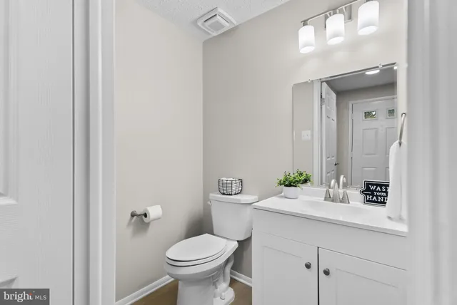 a bathroom with a sink toilet and a mirror