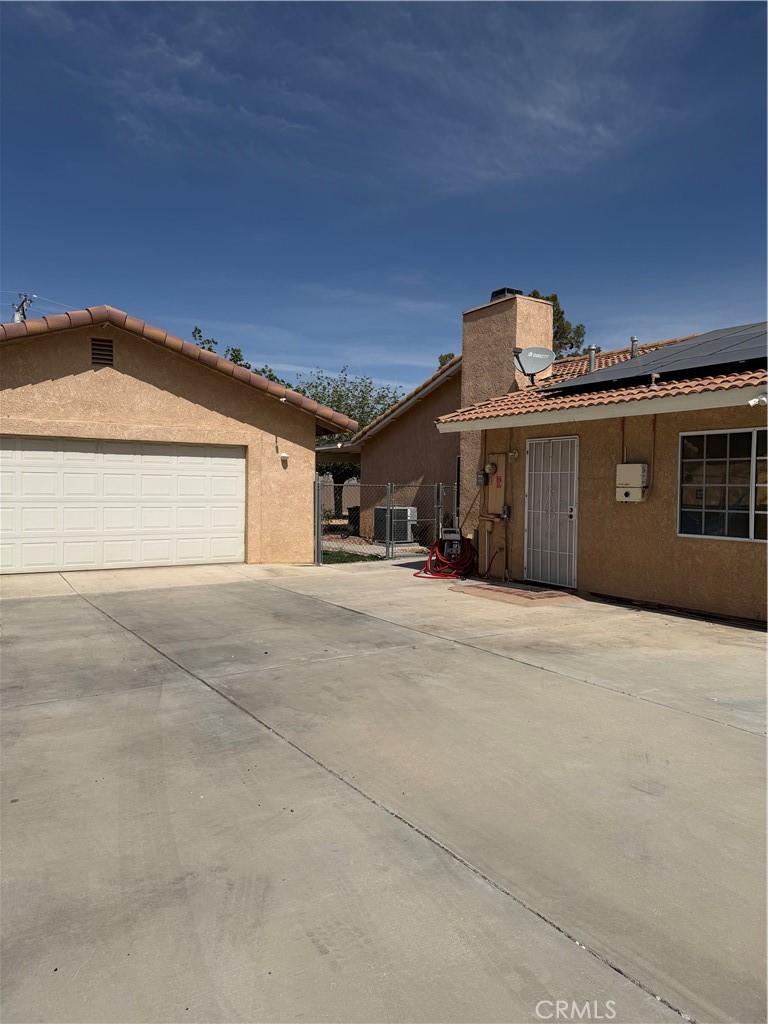 18602 Cocqui Road Apple Valley, CA 92307 - Photo 16 of 16 a front view of a house with a yard
