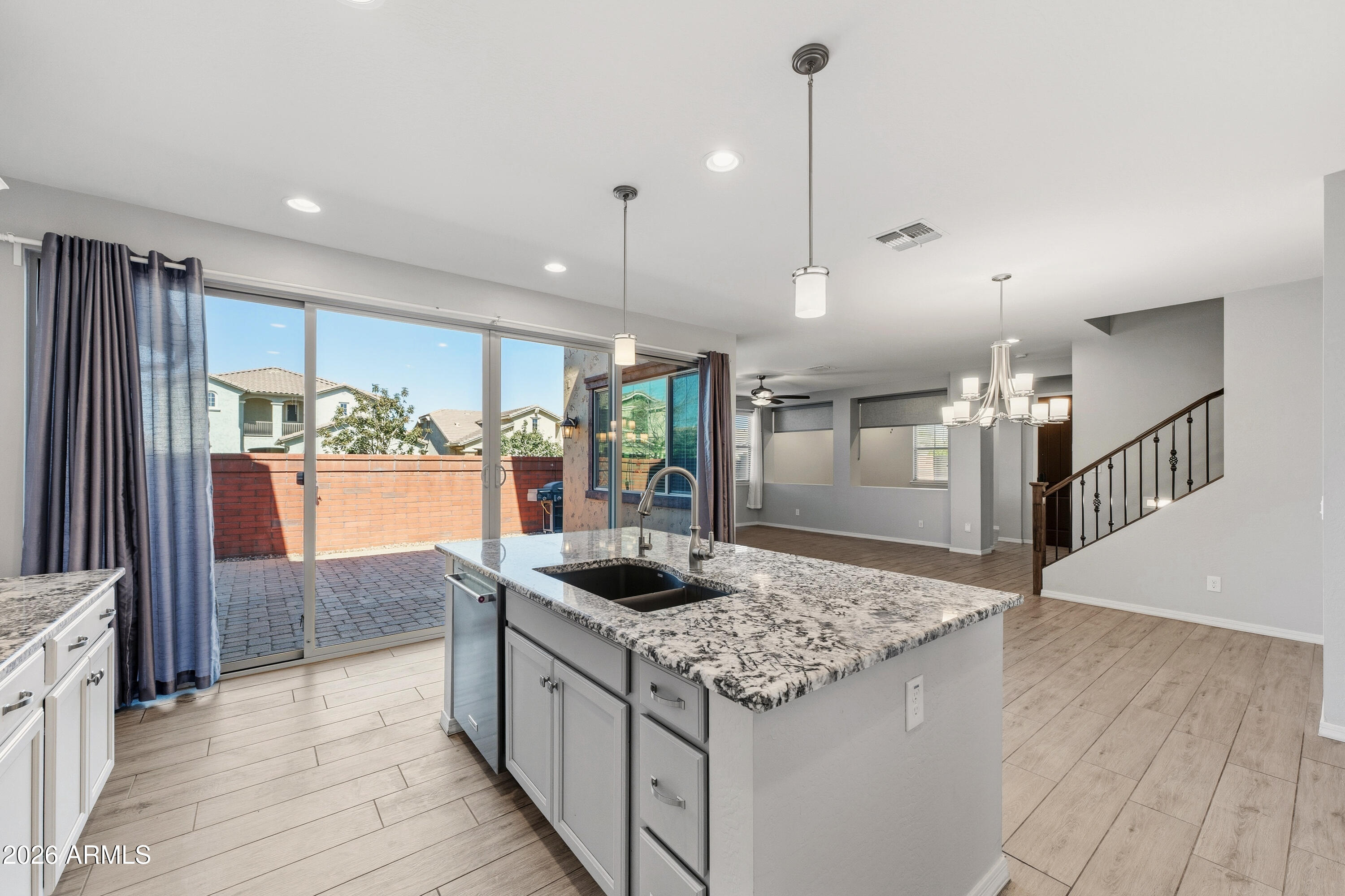 3909 East Perkinsville Street Gilbert, AZ 85295 - Photo 11 of 29 a kitchen with stainless steel appliances granite countertop a sink and a refrigerator