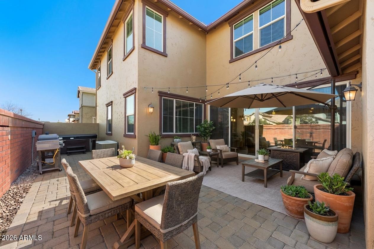 3909 East Perkinsville Street Gilbert, AZ 85295 - Photo 13 of 29 a view of a patio with couches table and chairs and potted plants