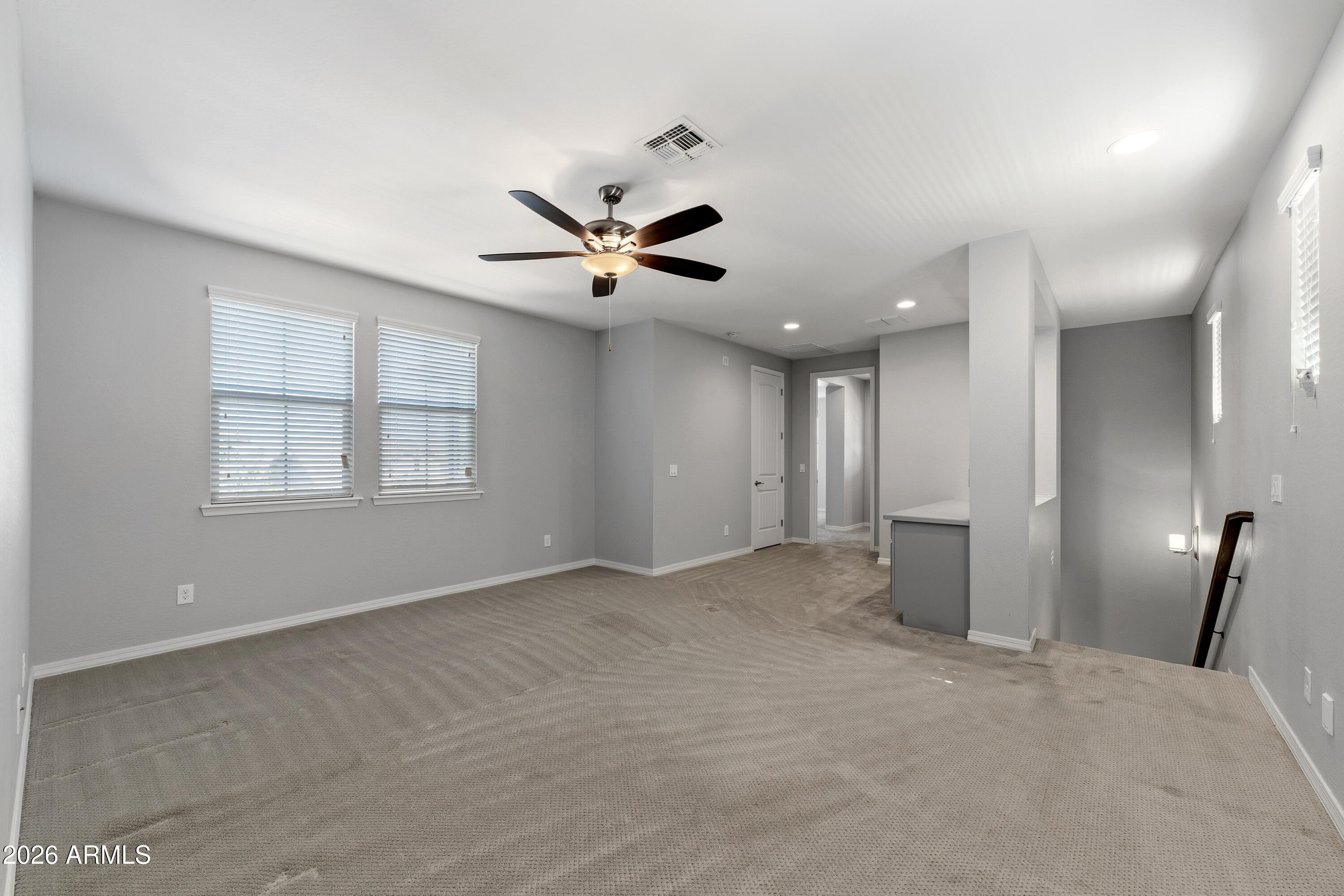 3909 East Perkinsville Street Gilbert, AZ 85295 - Photo 18 of 29 an empty room with windows and a ceiling fan