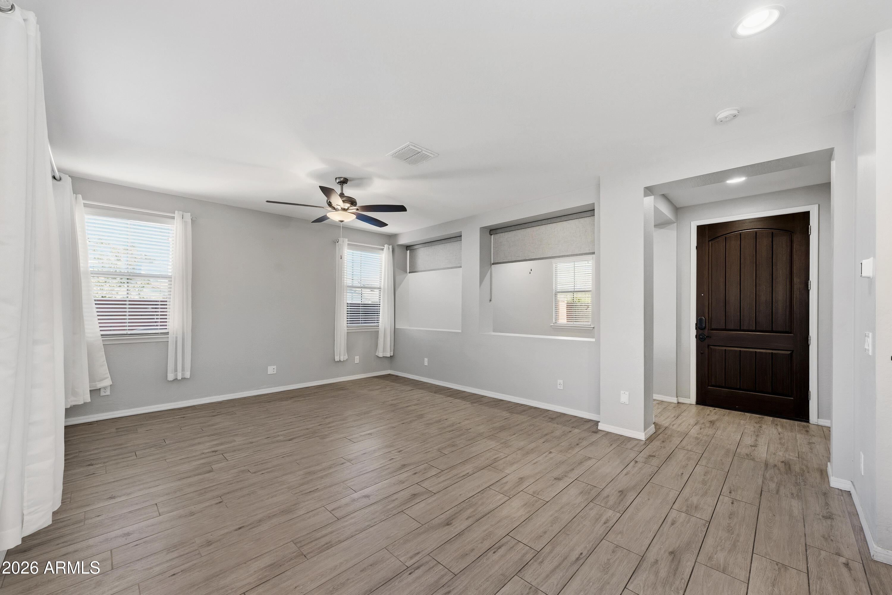 3909 East Perkinsville Street Gilbert, AZ 85295 - Photo 2 of 29 wooden floor in an empty room with a window