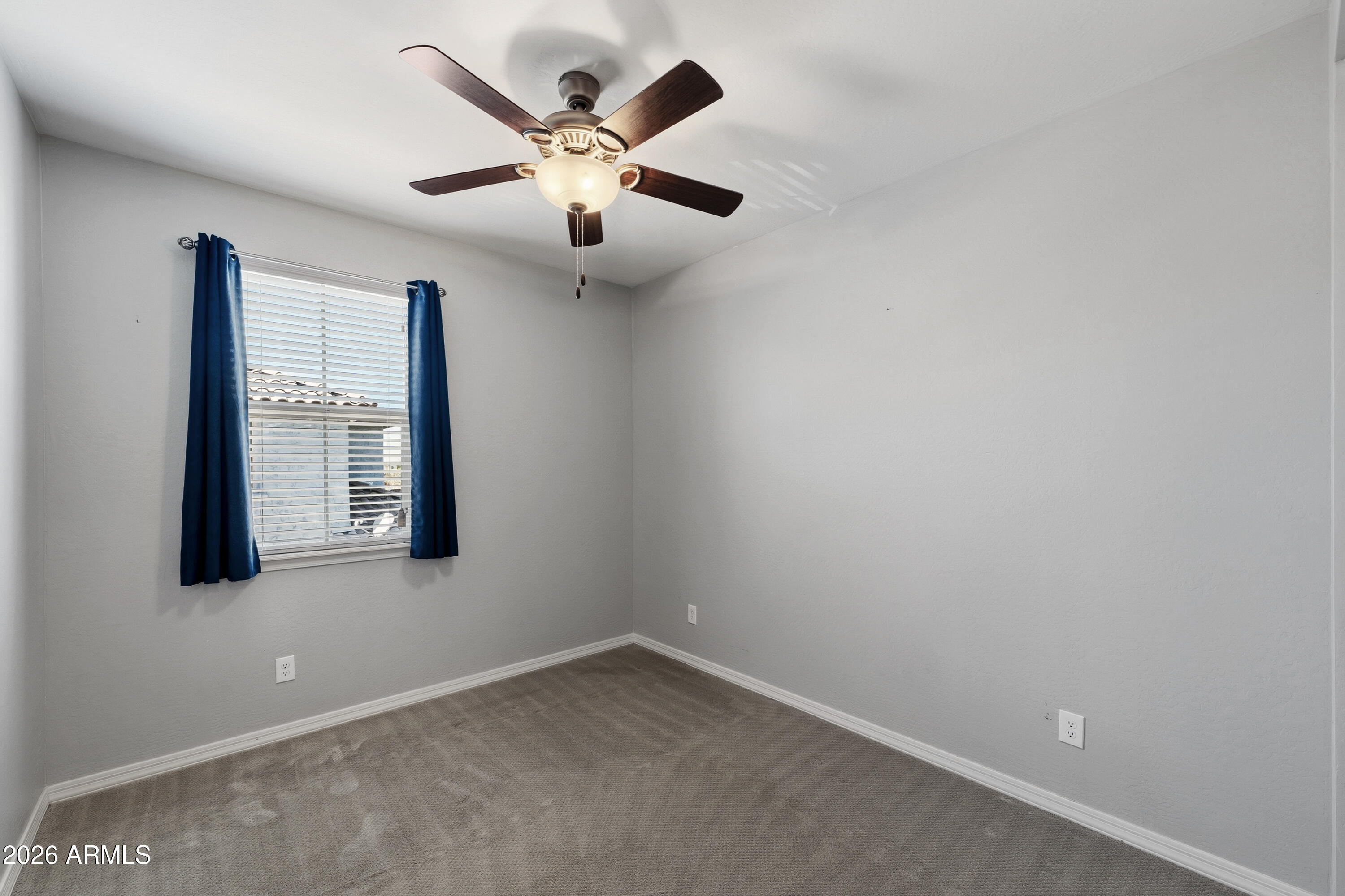 3909 East Perkinsville Street Gilbert, AZ 85295 - Photo 24 of 29 an empty room with a window and a fan