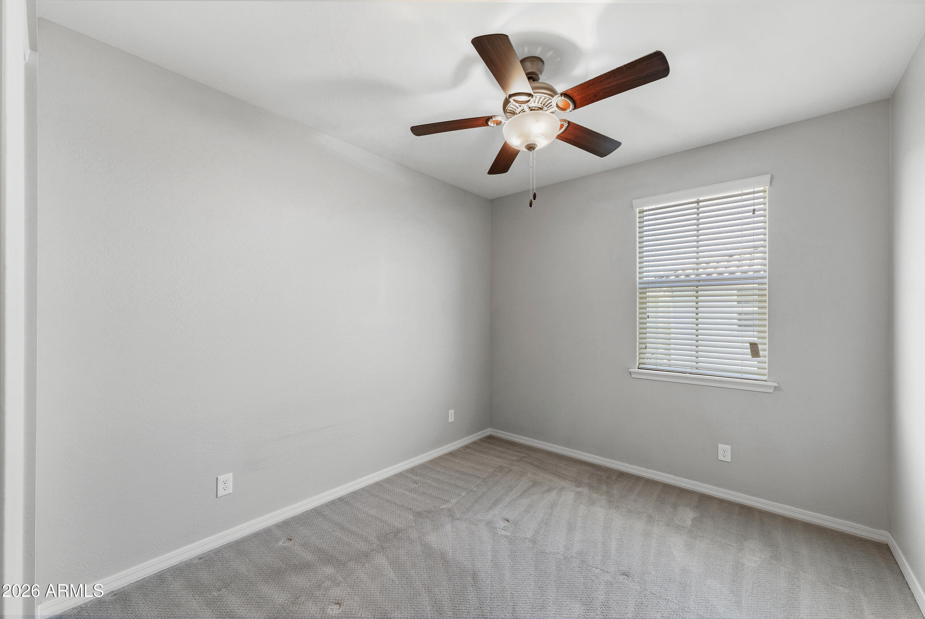 3909 East Perkinsville Street Gilbert, AZ 85295 - Photo 25 of 29 an empty room with a window and a fan