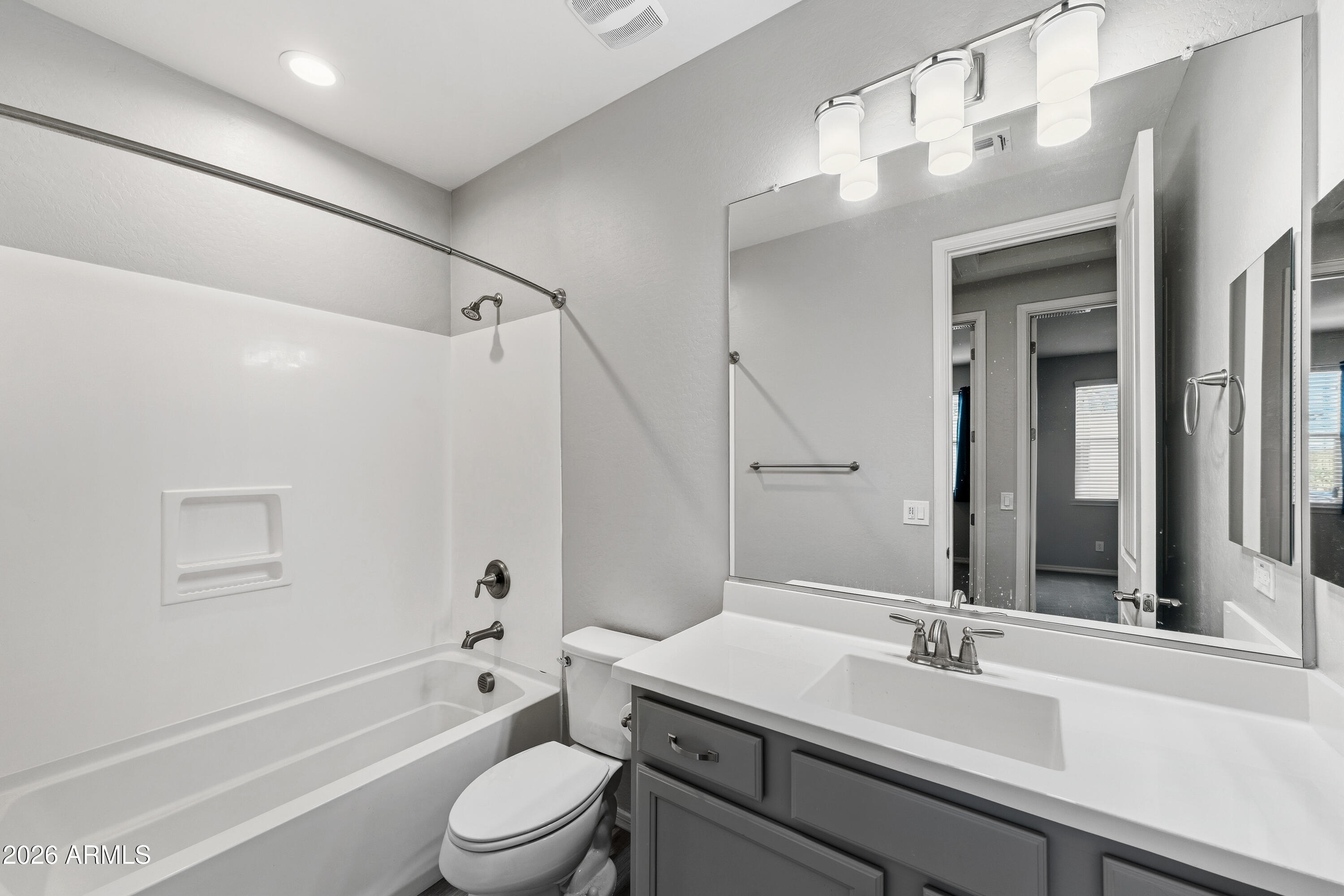 3909 East Perkinsville Street Gilbert, AZ 85295 - Photo 26 of 29 a bathroom with a sink a toilet a mirror and shower