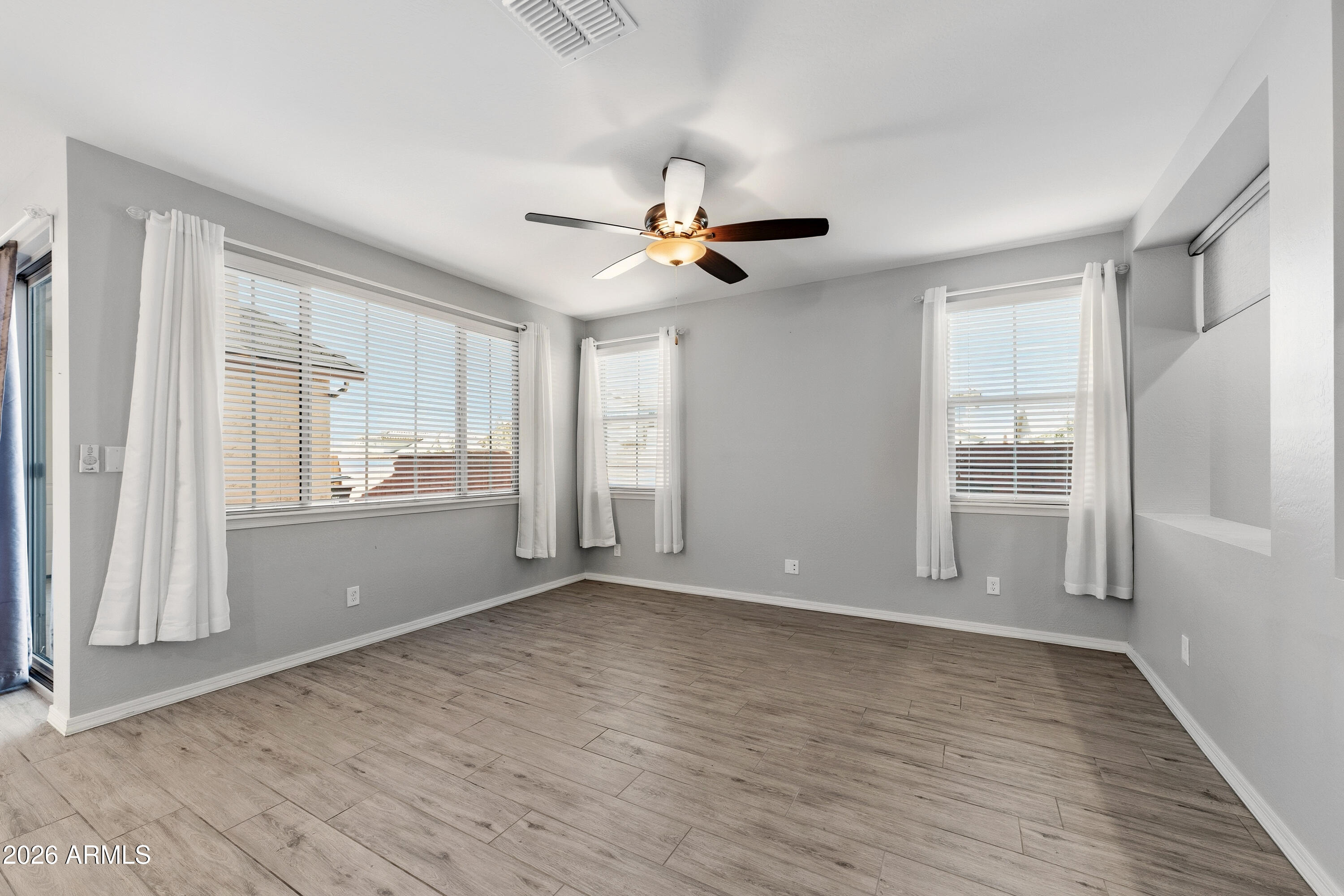 3909 East Perkinsville Street Gilbert, AZ 85295 - Photo 5 of 29 wooden floor in an empty room with a window