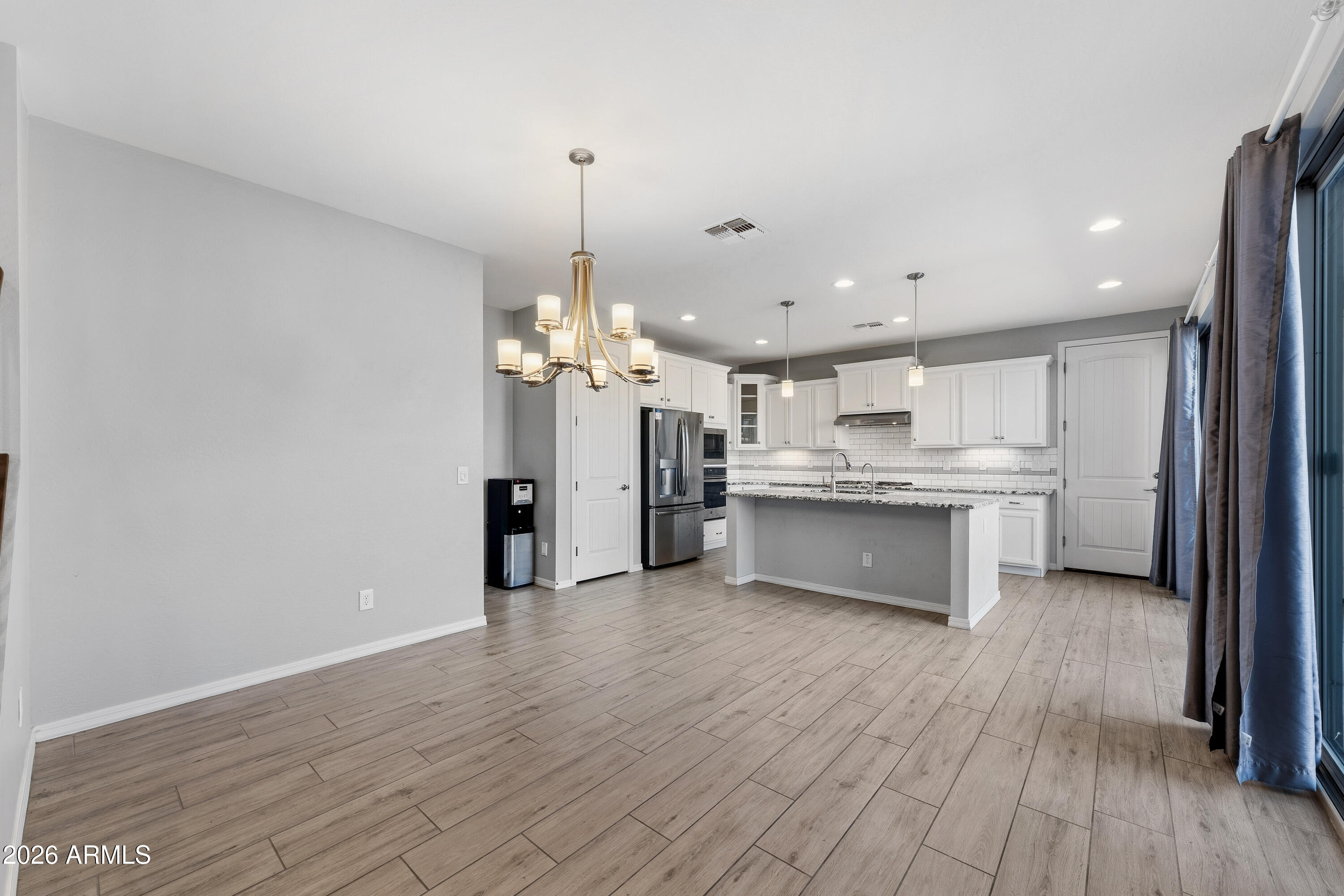 3909 East Perkinsville Street Gilbert, AZ 85295 - Photo 7 of 29 a large kitchen with a lot of cabinets and wooden floor