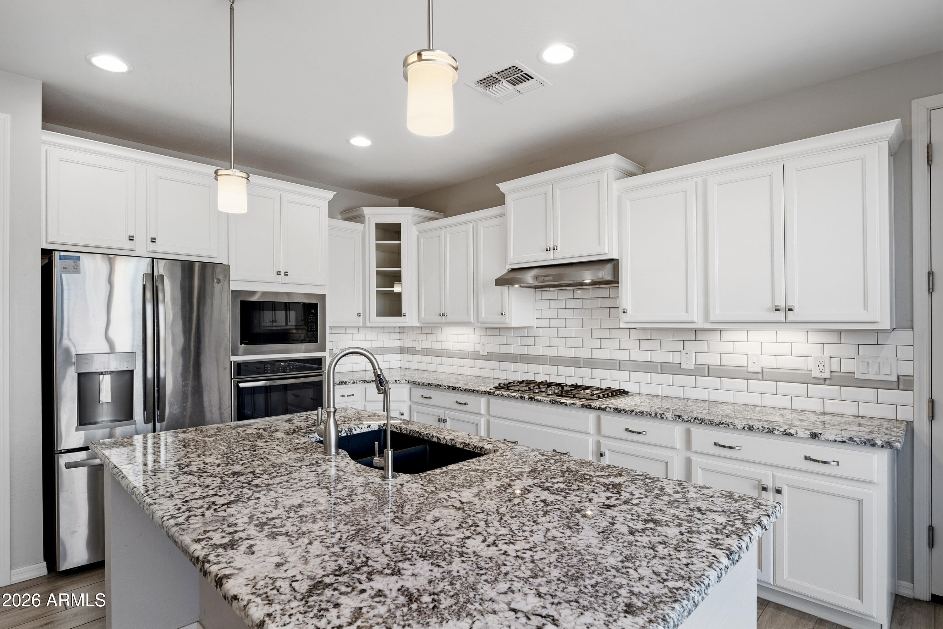 3909 East Perkinsville Street Gilbert, AZ 85295 - Photo 9 of 29 a kitchen with kitchen island a counter space a sink appliances and cabinets