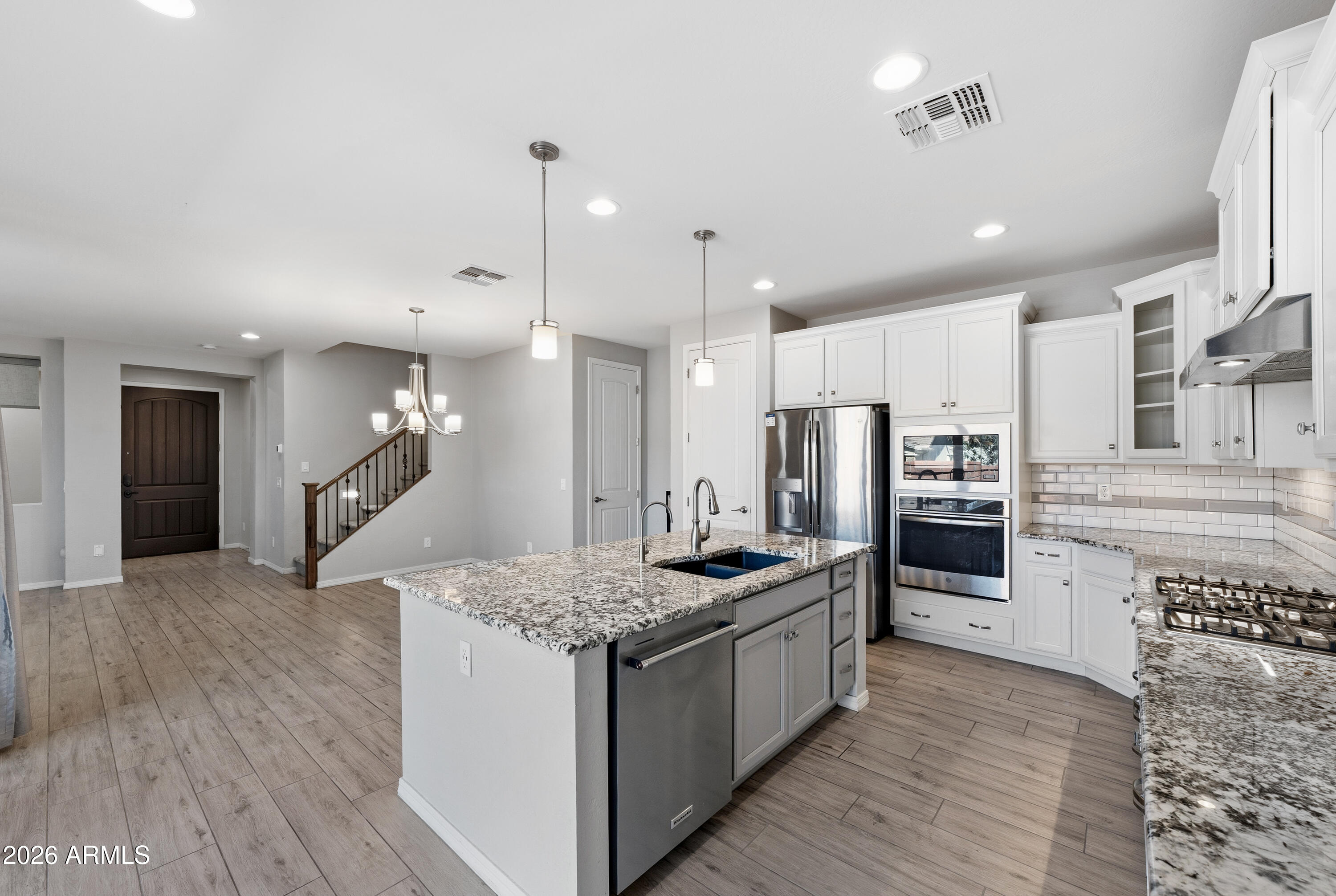 3909 East Perkinsville Street Gilbert, AZ 85295 - Photo 10 of 29 a kitchen with a refrigerator a sink and wooden floor