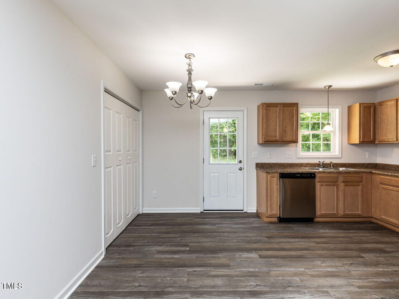 381 Gray Ghost Street Benson, NC 27504 - Photo 11 of 33 a kitchen with granite countertop a stove top oven a sink and dishwasher with wooden floor