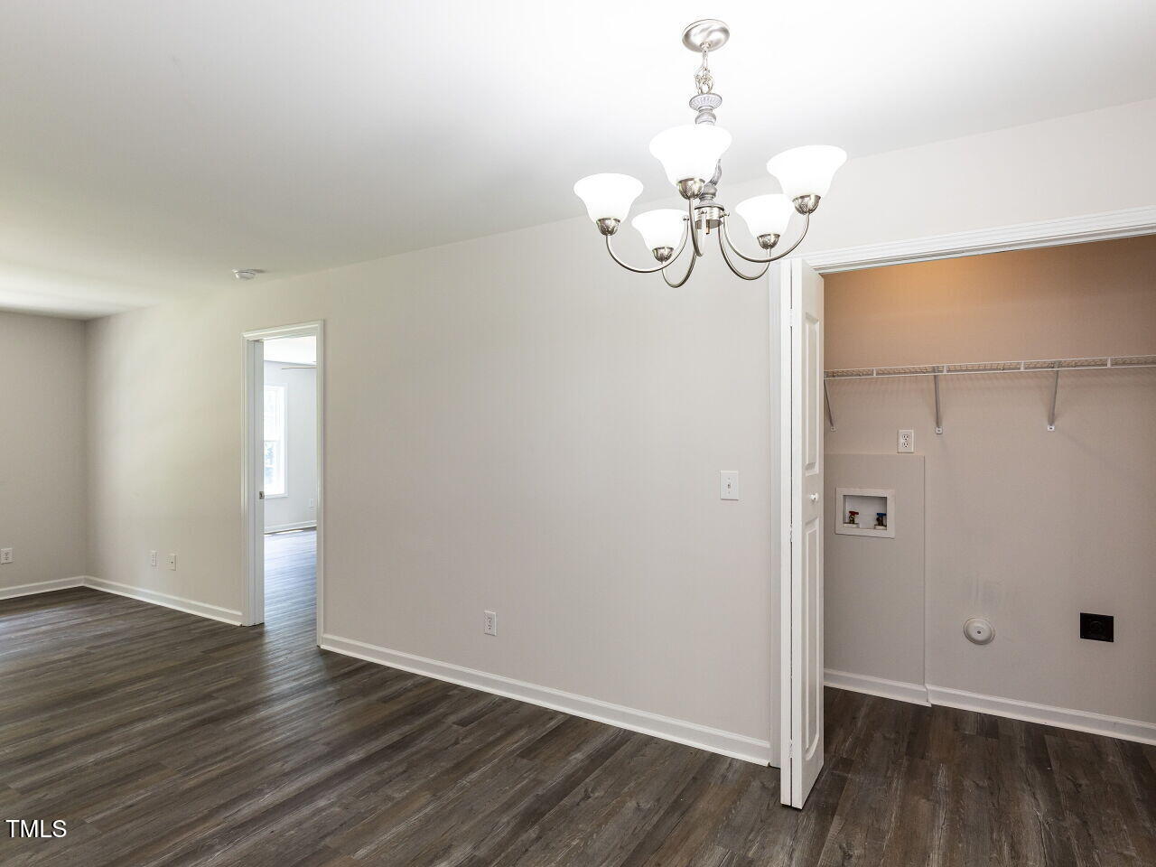 381 Gray Ghost Street Benson, NC 27504 - Photo 12 of 33 an empty room with wooden floor and chandelier