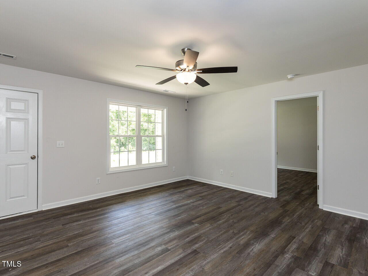 381 Gray Ghost Street Benson, NC 27504 - Photo 13 of 33 a view of an empty room with window and wooden floor