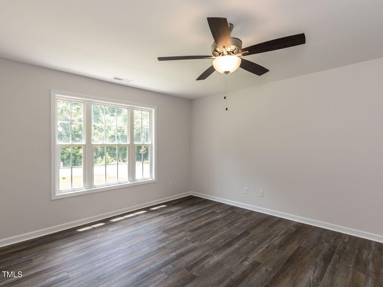 381 Gray Ghost Street Benson, NC 27504 - Photo 27 of 33 a view of an empty room with wooden floor and a window