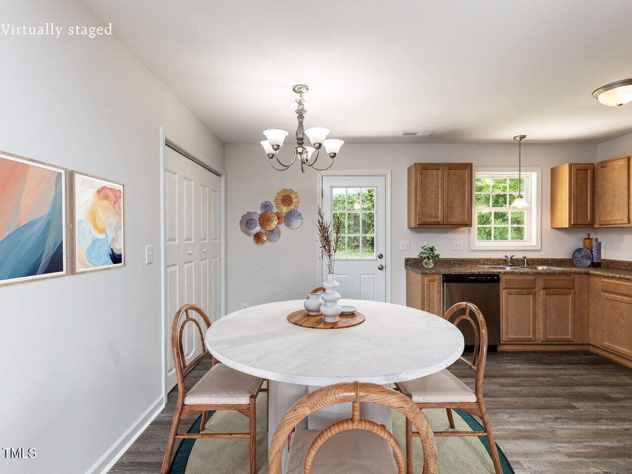 381 Gray Ghost Street Benson, NC 27504 - Photo 3 of 33 a kitchen with a dining table chairs stainless steel appliances and cabinets