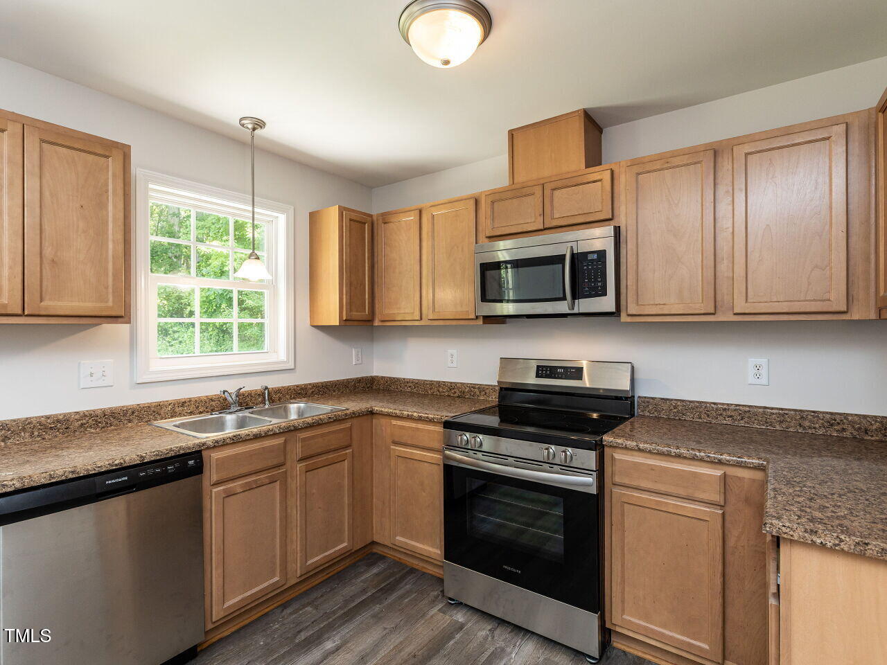381 Gray Ghost Street Benson, NC 27504 - Photo 9 of 33 a kitchen with granite countertop a sink and steel appliances