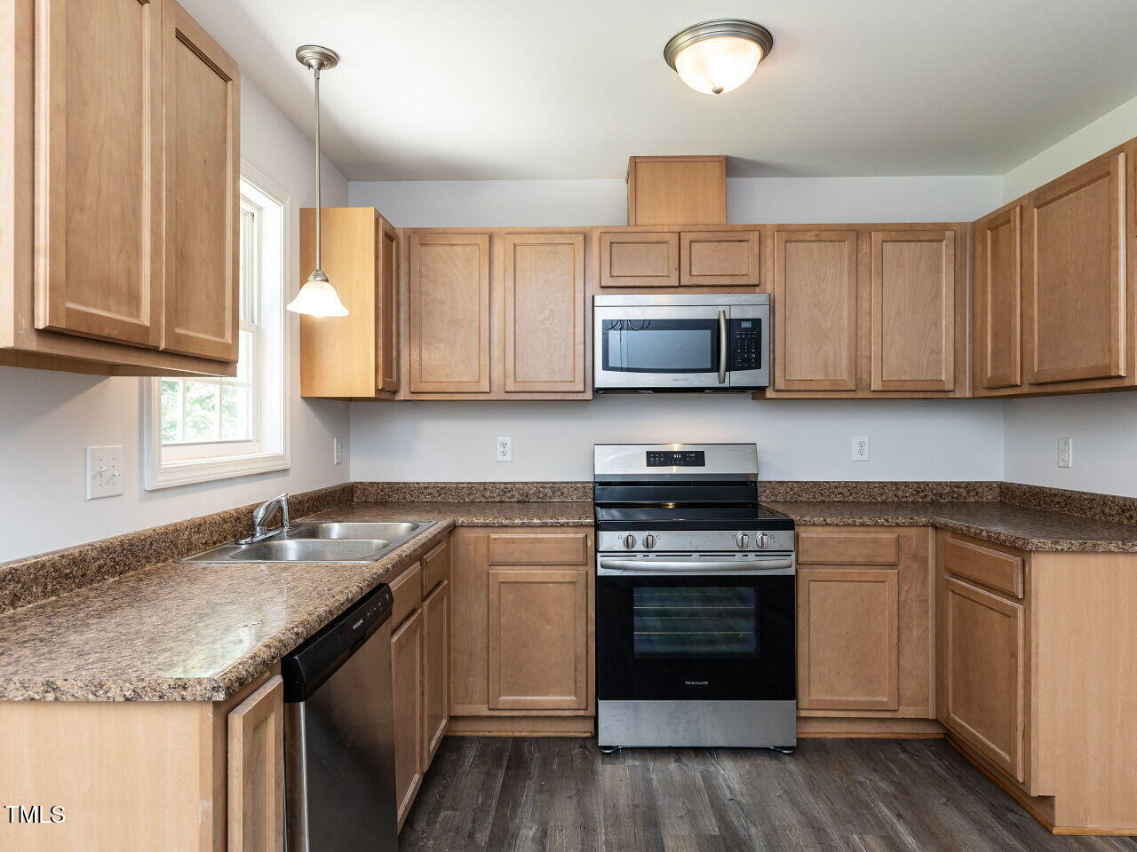 381 Gray Ghost Street Benson, NC 27504 - Photo 10 of 33 a kitchen with stainless steel appliances granite countertop a sink stove and microwave