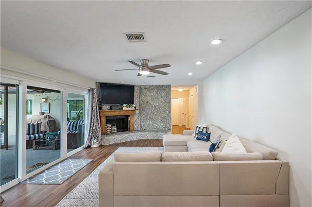 a living room with furniture and a view of kitchen