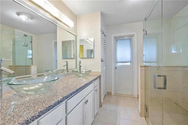 a bathroom with a shower and a mirror