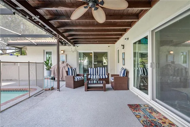 a living room with furniture ceiling fan and a window