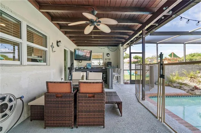 a swimming pool with large glass windows and yard