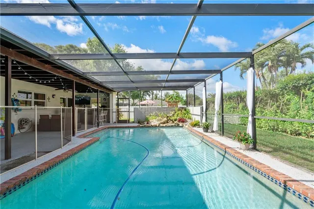 a view of house with backyard and a slide