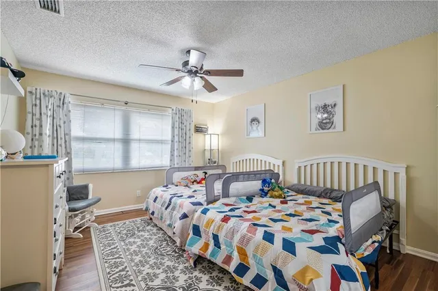 a bathroom with a granite countertop sink a toilet and a mirror