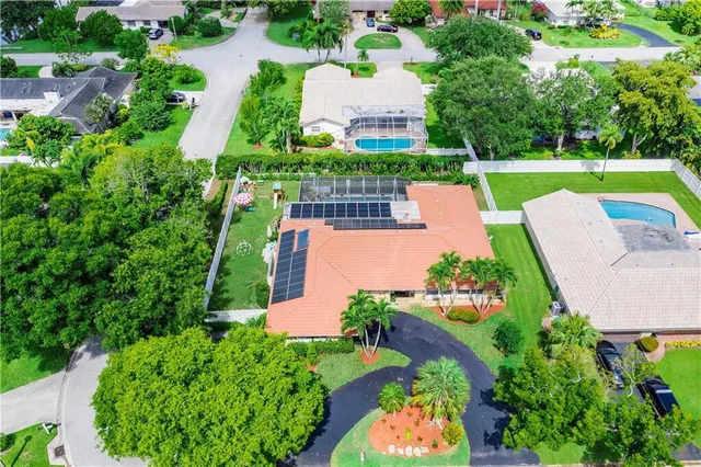 an aerial view of a house with outdoor space and street view