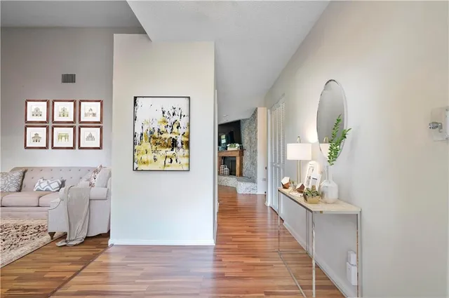 a living room with furniture and wooden floor