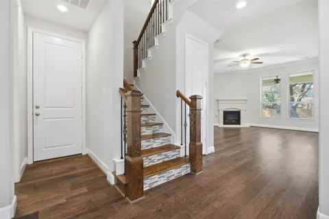 a view of entryway and hall with wooden floor