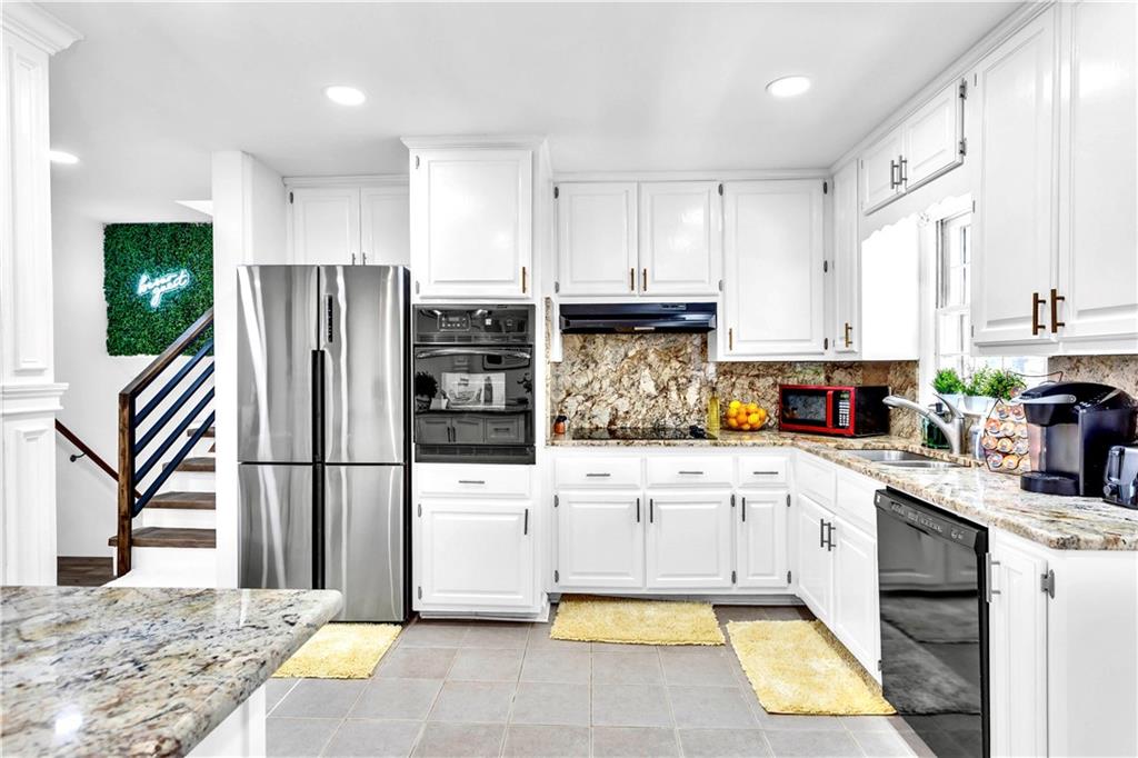 3571 Turner Heights Drive Decatur, GA 30032 - Photo 14 of 51 a kitchen with stainless steel appliances kitchen island granite countertop a refrigerator sink and cabinets