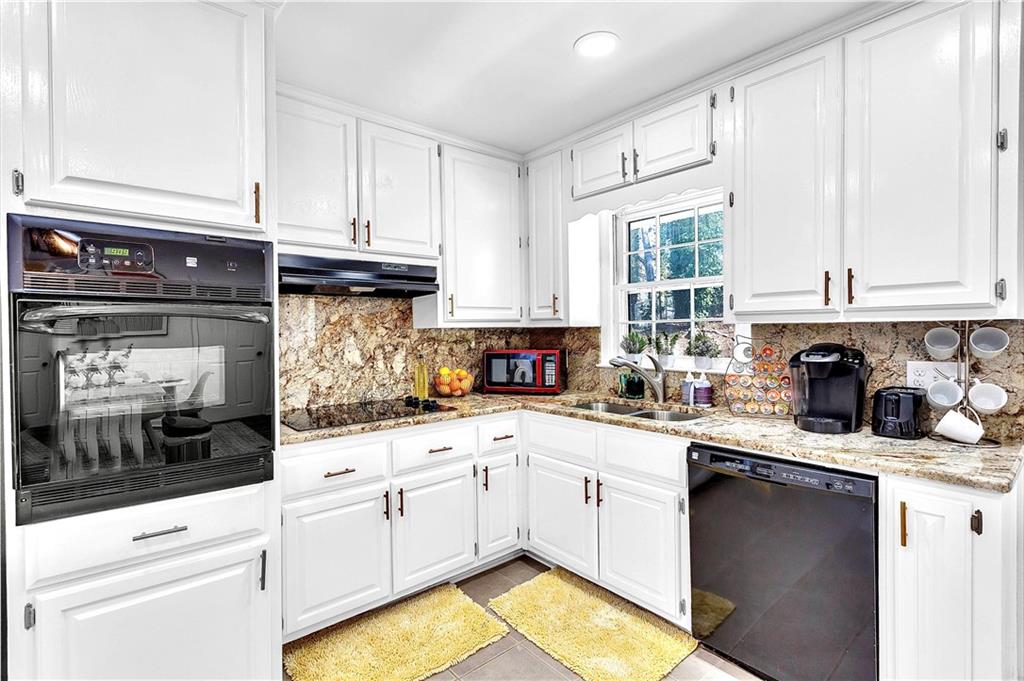 3571 Turner Heights Drive Decatur, GA 30032 - Photo 15 of 51 a kitchen with stainless steel appliances granite countertop a sink stove and cabinets