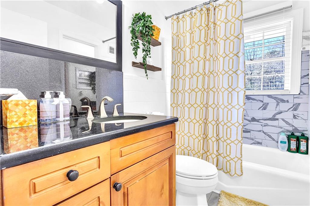 3571 Turner Heights Drive Decatur, GA 30032 - Photo 38 of 51 a bathroom with a sink a toilet and shower curtain